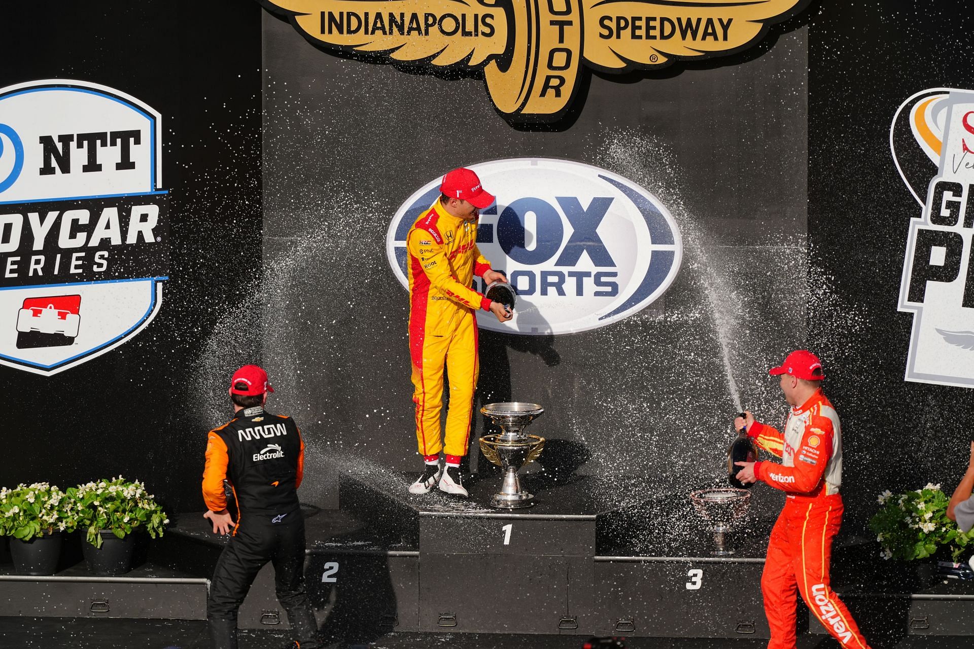 Pato O'Ward (L), Alex Palou, and Will Power (R) at the INDYCAR Sonsio Grand Prix podium - Source: Getty